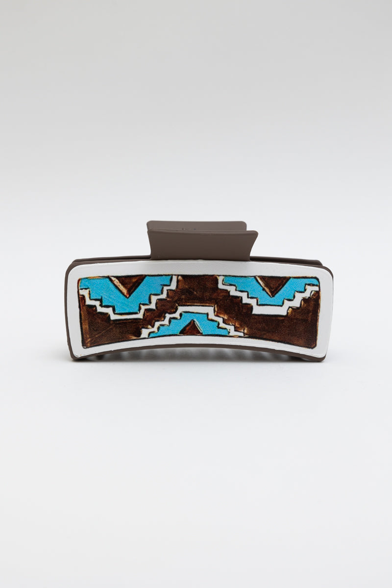 Geometric pattern hair claw clip with blue and brown design.